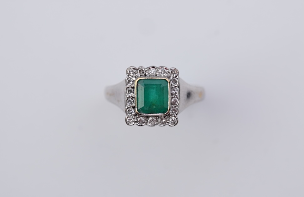 An emerald and diamond ring